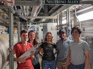 Five Duke graduate students inside Neutrino Alley, a basement-corridor-turned-laboratory below the Spallation Neutron Source facility at Oak Ridge National Lab.